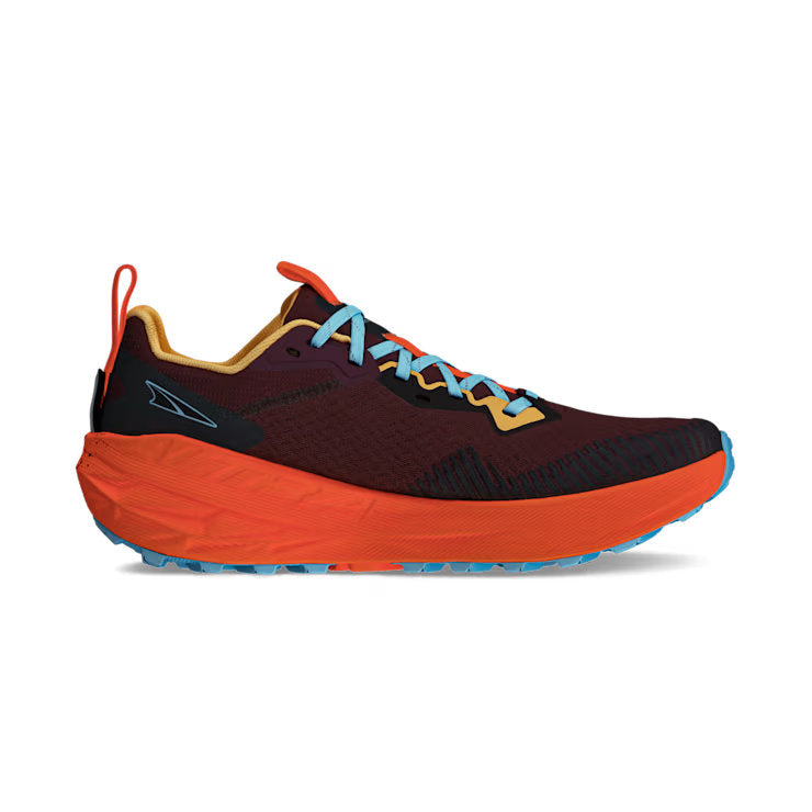 Side view of a red trail running shoe with orange accents against a white background. 