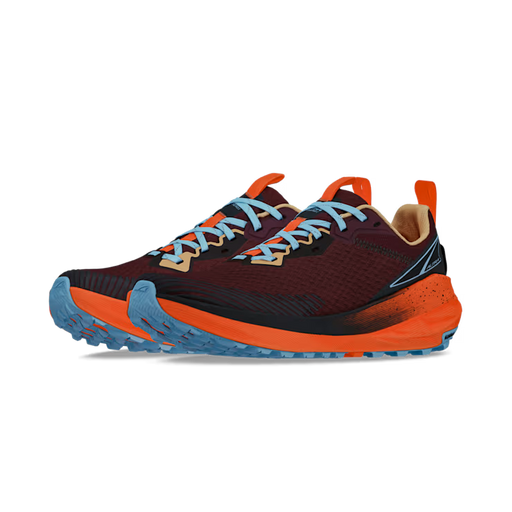 Side view of a pair of red shoes with orange accents and blue laces against a white background. 