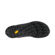 The bottom of a black running shoe on a white background