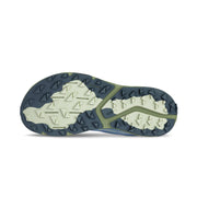 The bottom of a blue running shoe on a white background