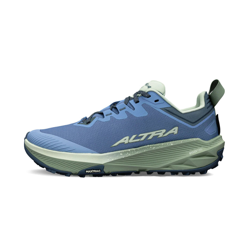 A blue running shoe with a green bottom on a white background