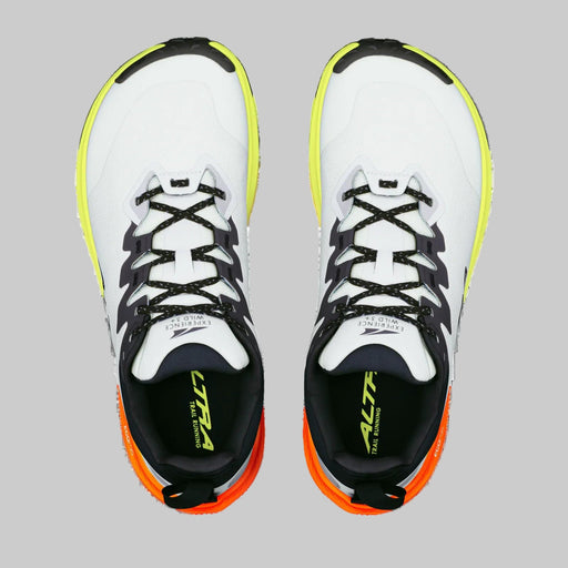 A pair of white running shoes from above on a white background