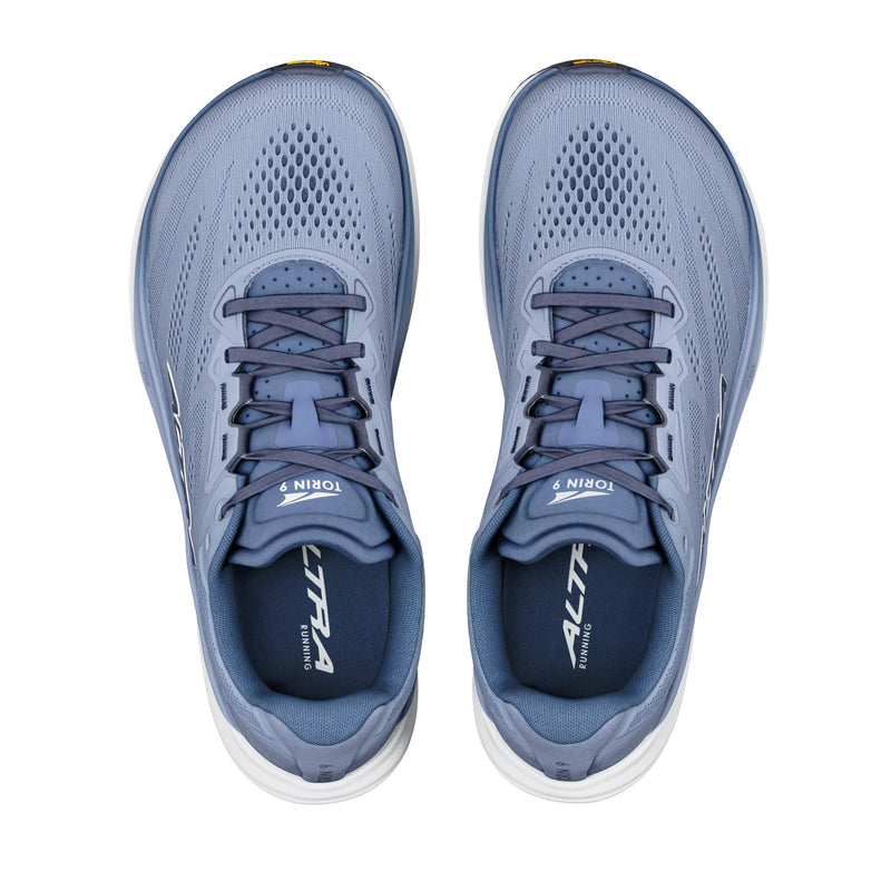 A pair of light blue running shoes from above on a white background