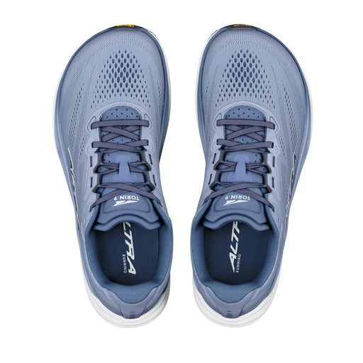A pair of light blue running shoes from above on a white background