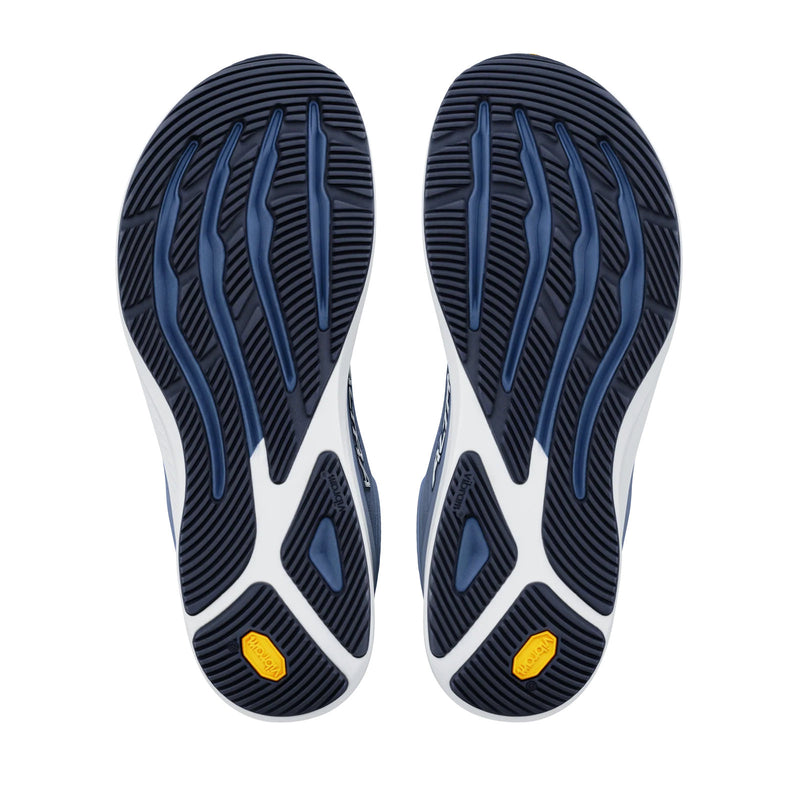 The bottom of a pair of running shoes on a white background