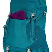A blue hiking backpack holding a purple knitted piece on a white background