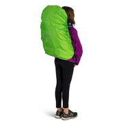 A person wearing a hiking backpack with a green cover on a white background