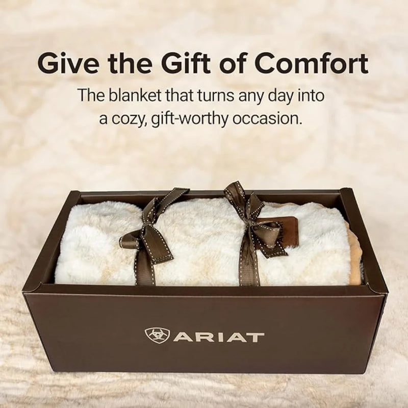 White blanket with brown ribbons in a box, Ariat logo visible, text 'Give the Gift of Comfort'.