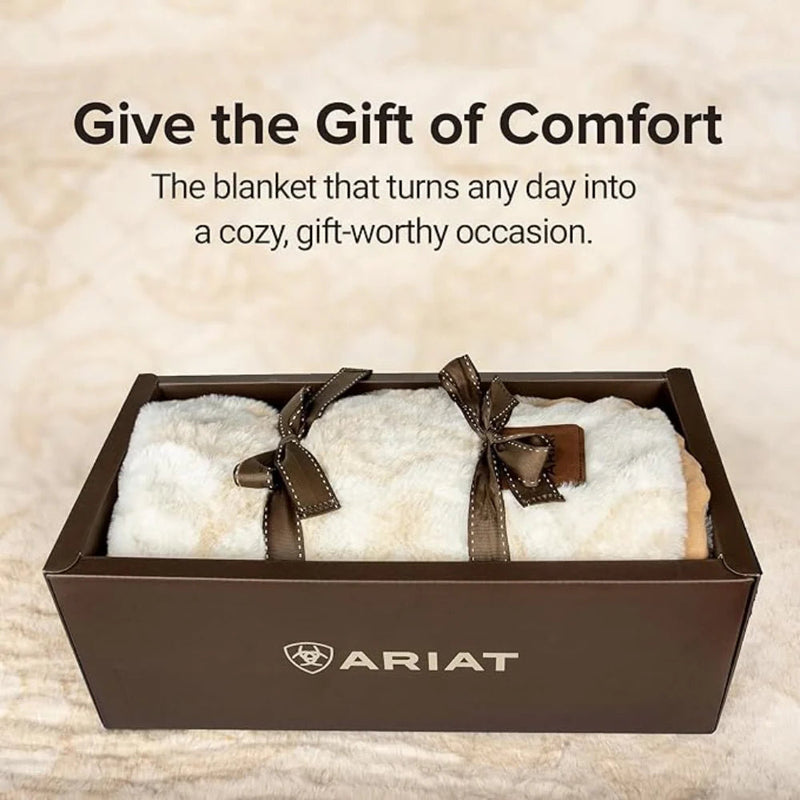 White blanket with brown ribbons in a box, Ariat logo visible, text 'Give the Gift of Comfort'.