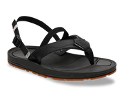 Side view of a black sandal with a brown tread against a white background. 