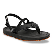 Side view of a black sandal with a brown tread against a white background. 