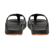 Back view of a pair of pair of black sandals against a white background. 