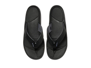 Top-down view of a pair of black sandals against a white background. 