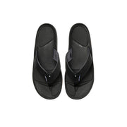 Top-down view of a pair of black sandals against a white background. 
