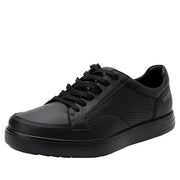 Side view of a completely black shoe against a white background. 