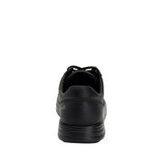 Back view of a completely black shoe against a white background. 
