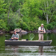 Two men fishing in a fishing boat on a lake.