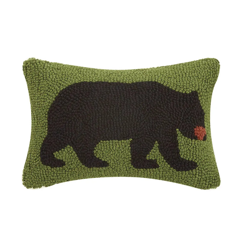 Green rectangular pillow featuring a black bear design against a white background. 
