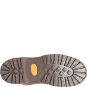 The brown rubber sole of a Carolina work boot