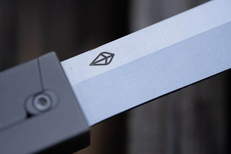 A close up on the logo on the blade of a pocket knife