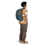 Person wearing a blue backpack on a white background