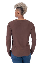 Person wearing a brown long-sleeve shirt on a white background