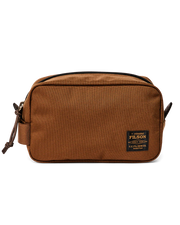 Light brown travel bag with Filson logo against a white background. 