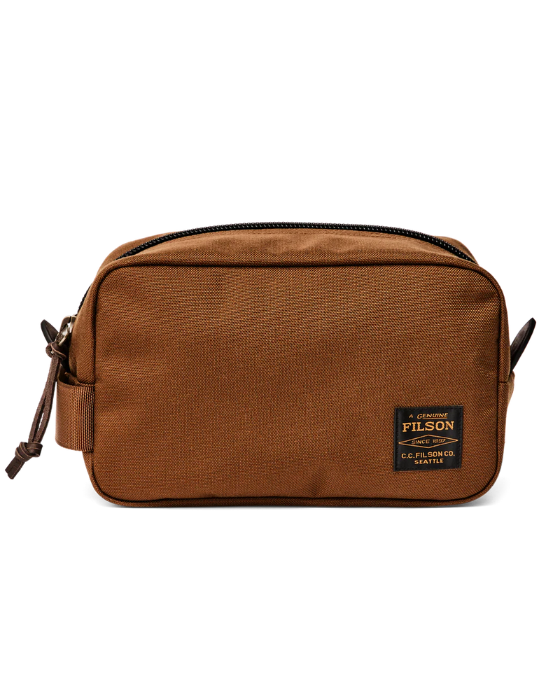 Light brown travel bag with Filson logo against a white background. 