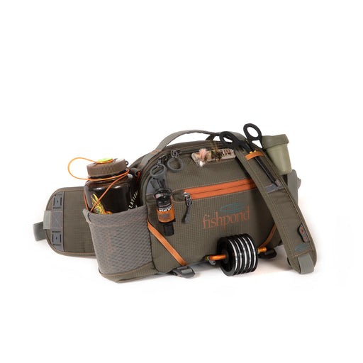 A dark green bag filled with fishing gear on a white background