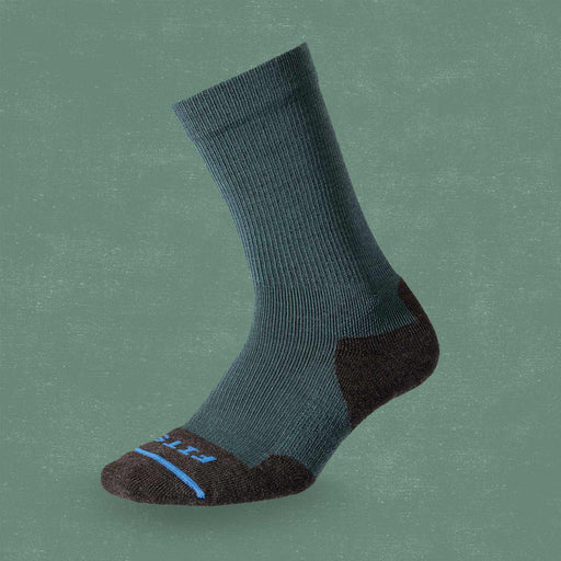 A gray and black sock on a dark green background