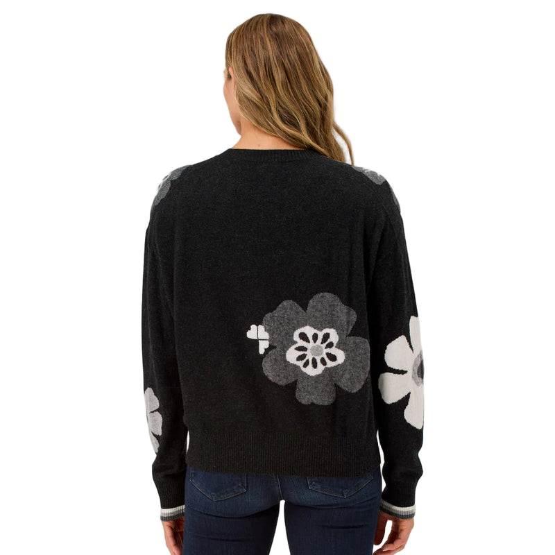 Black sweater with floral patterns on a plain background