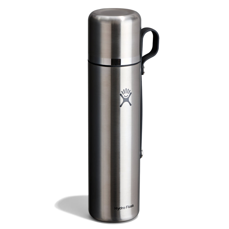 A Hydro Flask stainless steel vacuum flask with a black handle, shown on a white background with a soft shadow.