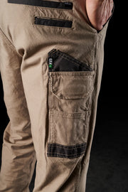 Close-up of beige cargo pants with multiple pockets on a black background