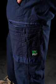 Navy blue work pants with a visible FXD logo on a dark background