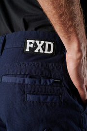 Navy blue pants with FXD logo on the back pocket against a black background