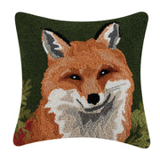Green pillow featuring a fox design against a white background. 