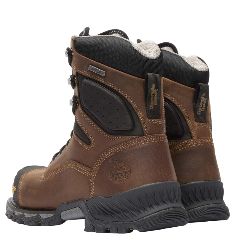 Pair of brown hiking boots with black soles on a white background