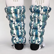 Back view of a model wearing white and blue gaiters against a white background.