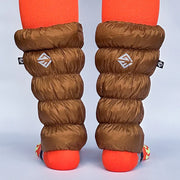 Back view of a model wearing light brown gaiters over orange socks against a white background. 