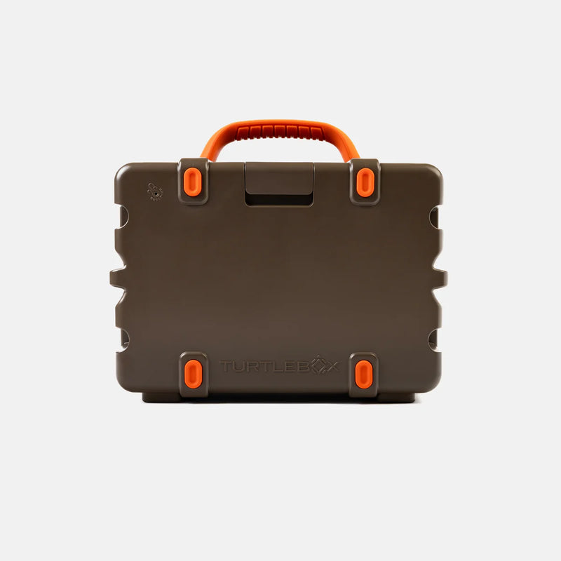 Brown hard-shell speaker with orange handles and accents on a light gray background