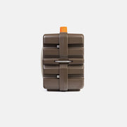 Brown rectangular Turtlebox speaker  with a strap and orange top on a white background shown from the side