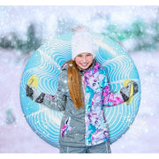 Girl holding an inflatable tube on a snowy mountain. 