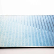 Close up of the center of a blue snowboard against a white background. 