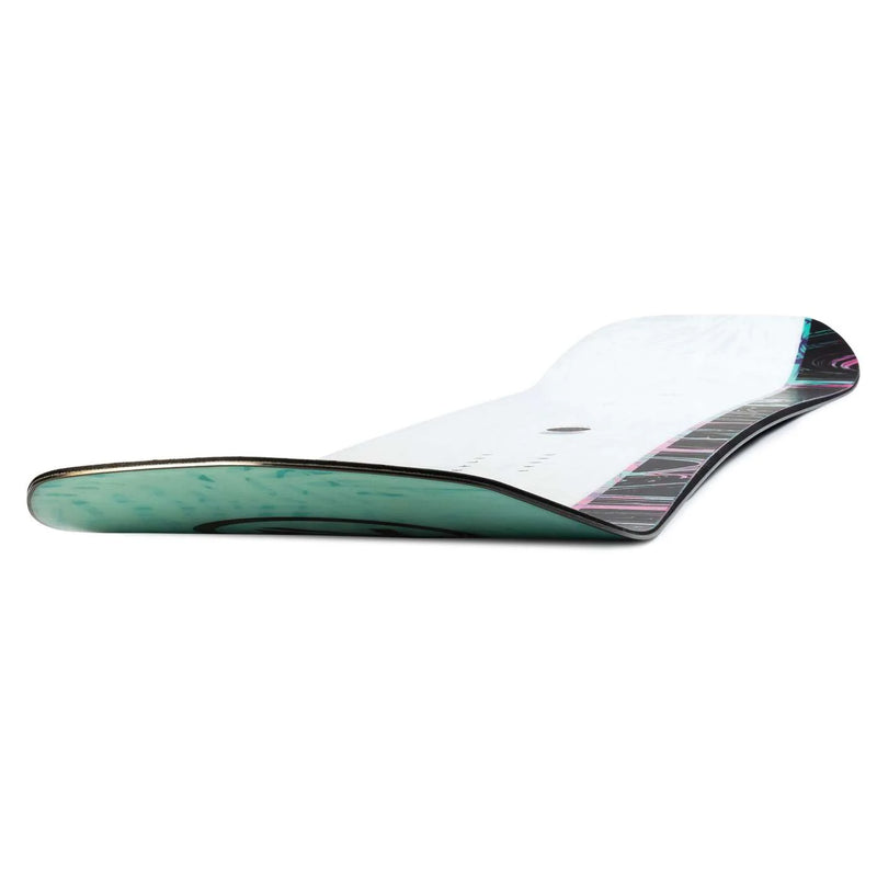 Close up front view of a black snowboard with teal and purple patterns against a white background. 