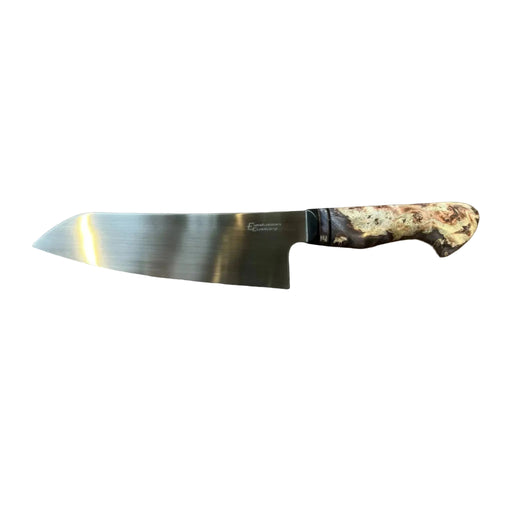 A chef's knife with a satin-finished stainless steel blade and a textured, marbled handle in earthy brown, beige, and black tones, displayed on a rustic brown wooden surface.