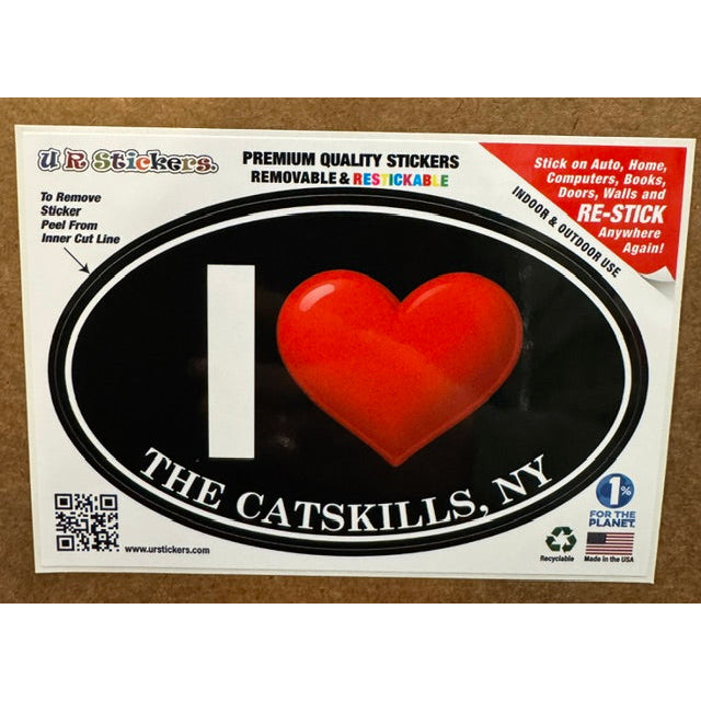 A black and red sticker with the text "i heart the catskills" on a wooden background.