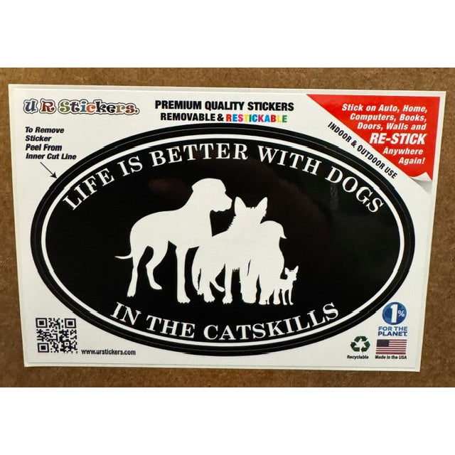 Black and white sticker with the text "life is better with dogs in the catskills" on a wooden background.