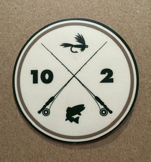 A circular white sticker featuring black crossed fishing rods, a fly lure, a fish silhouette, and the numbers 10 and 2