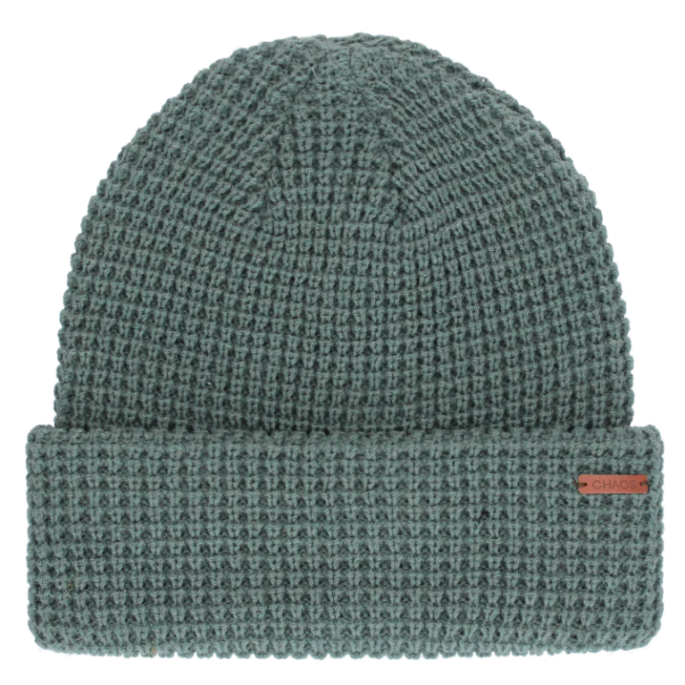 Teal knit beanie against a white background. 
