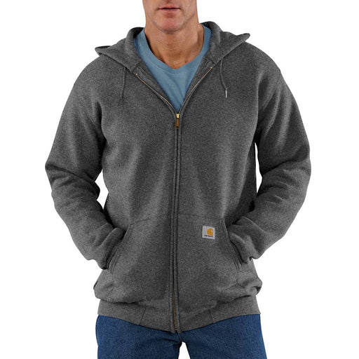 A person wearing a gray zip up hoodie with hand in their pockets on a white background